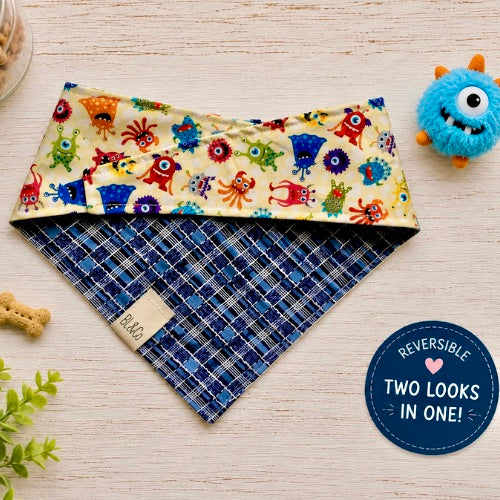 Friendly Monsters reversible dog bandana with colorful monster print and navy plaid reverse side.