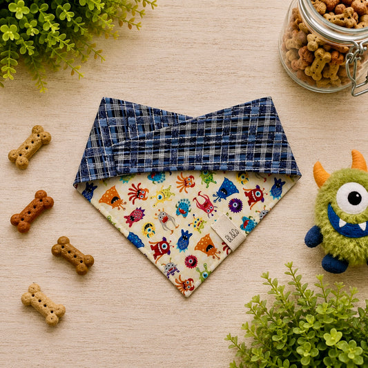 Friendly Monsters reversible dog bandana with colorful monster print and navy plaid reverse side.